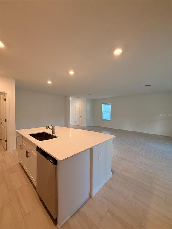 17602 Pleasantview Boulevard Land O Lakes, FL 34638 - Photo 7 of 27 a kitchen with stainless steel appliances granite countertop a sink and a stove