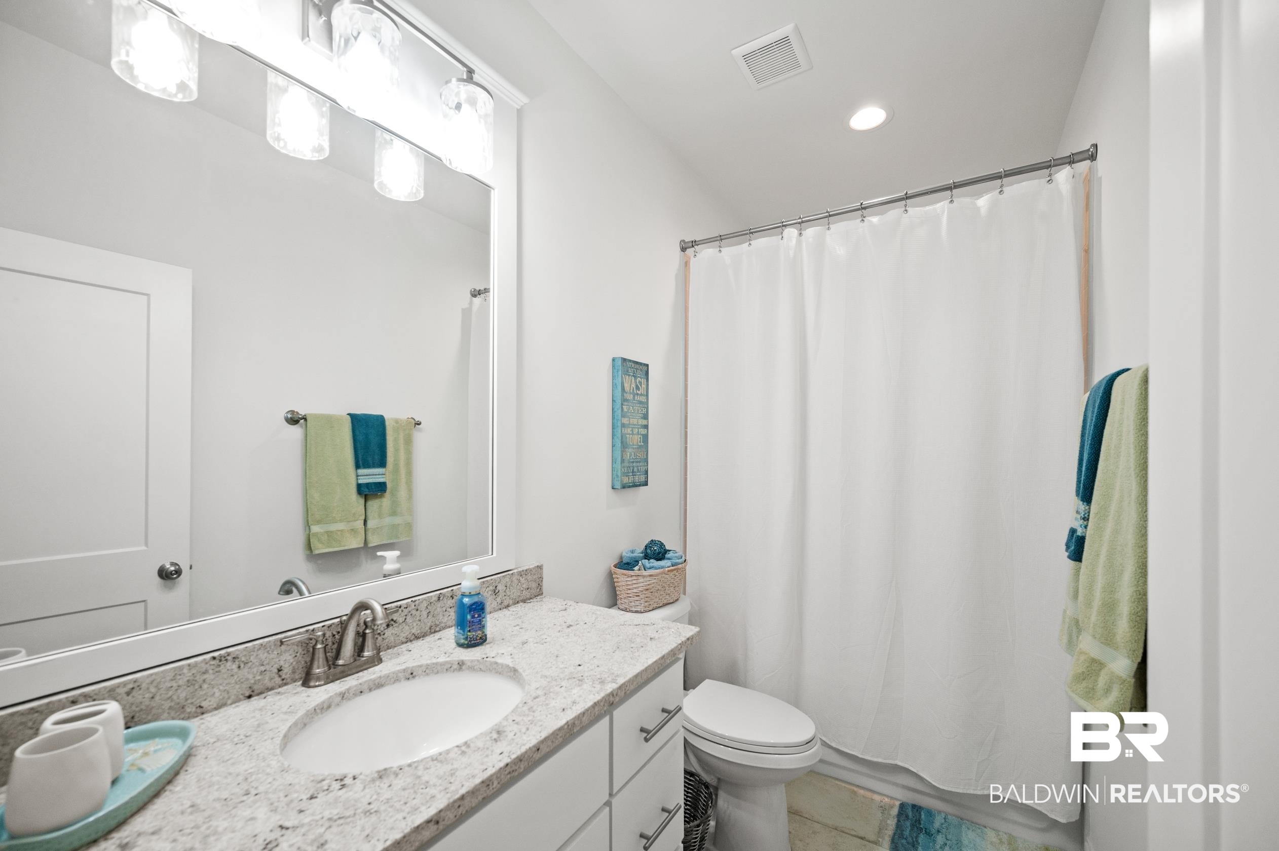 4601 Surrey Lane Orange Beach, AL 36561 - Photo 27 of 43 Bathroom with tile patterned flooring, vanity, toilet, and curtained shower