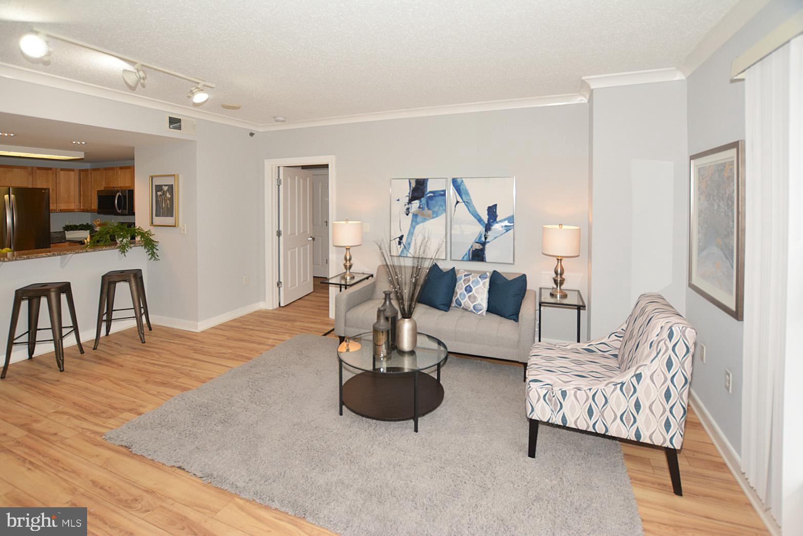 777 7th Street Northwest, Unit 1014 Washington, DC 20001 - Photo 11 of 43 a living room with furniture and a wooden floor