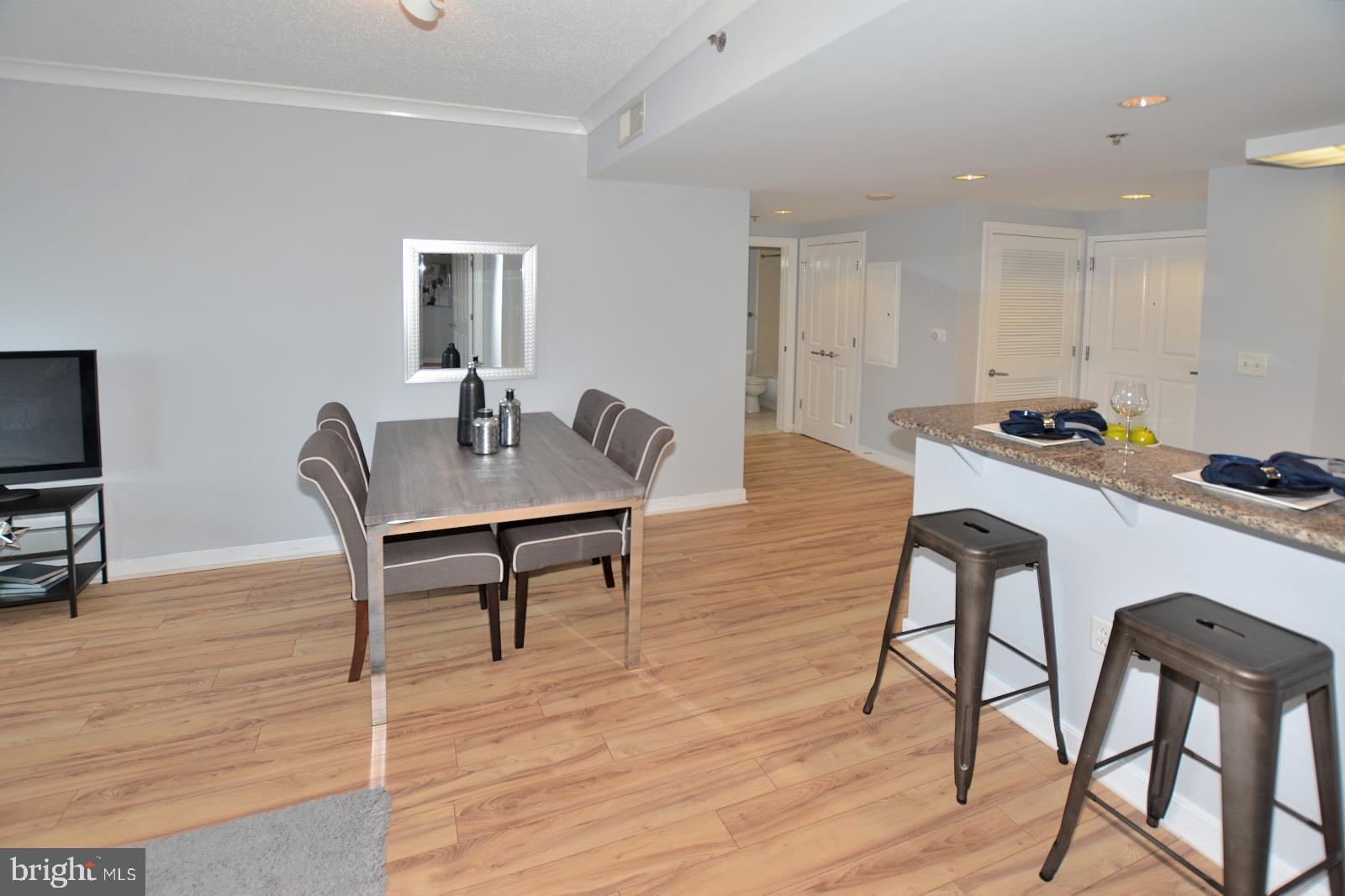 777 7th Street Northwest, Unit 1014 Washington, DC 20001 - Photo 12 of 43 a view of a dining room with furniture and wooden floor