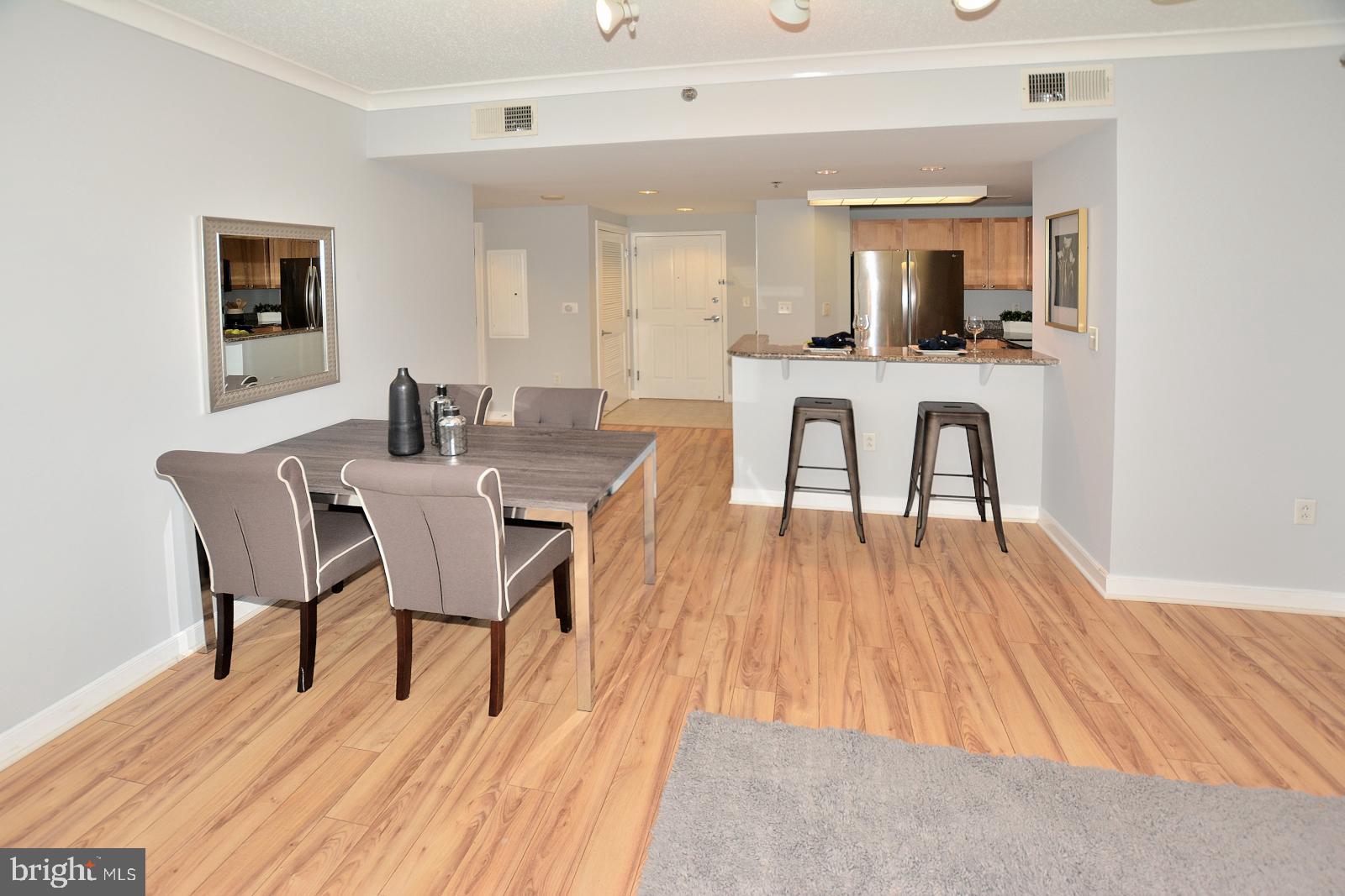 777 7th Street Northwest, Unit 1014 Washington, DC 20001 - Photo 13 of 43 a view of a dining room with furniture and wooden floor