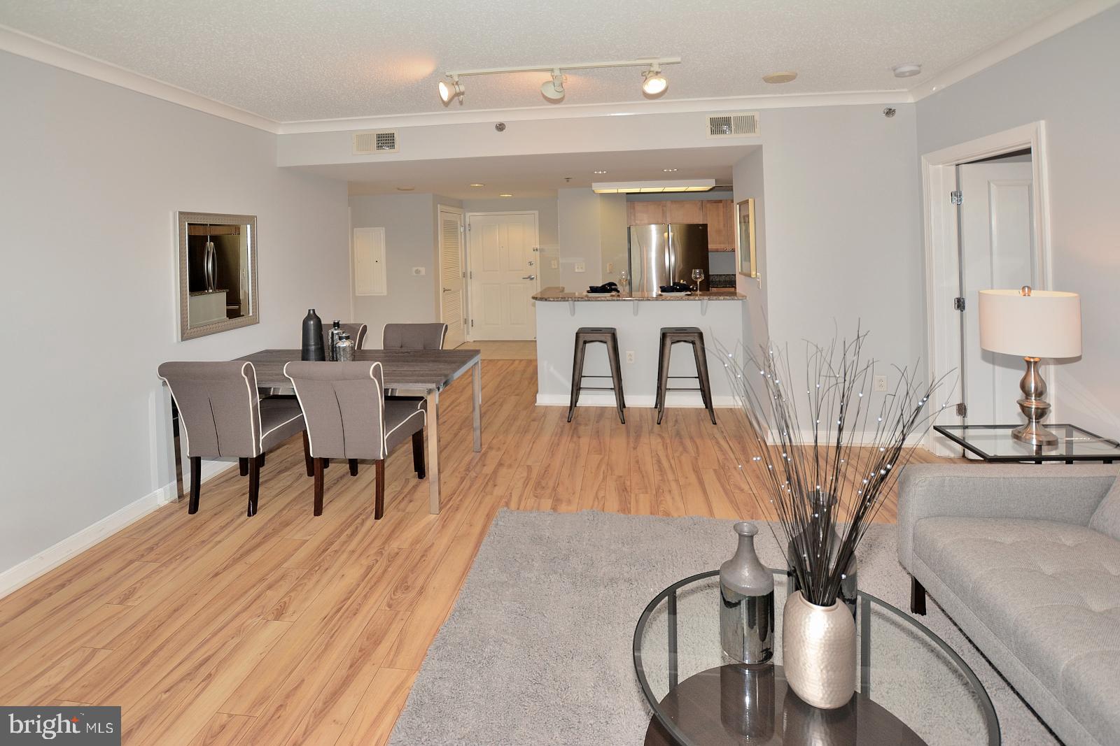 777 7th Street Northwest, Unit 1014 Washington, DC 20001 - Photo 15 of 43 a view of a dining room with furniture and wooden floor