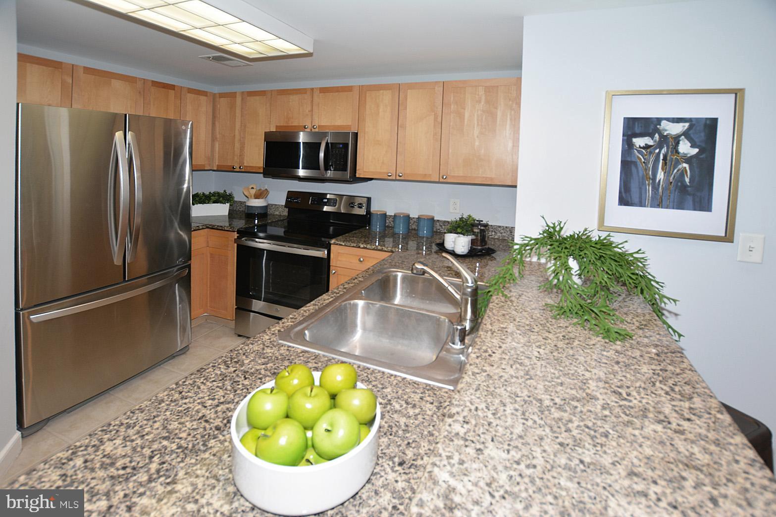 777 7th Street Northwest, Unit 1014 Washington, DC 20001 - Photo 19 of 43 a kitchen with a refrigerator sink and stove