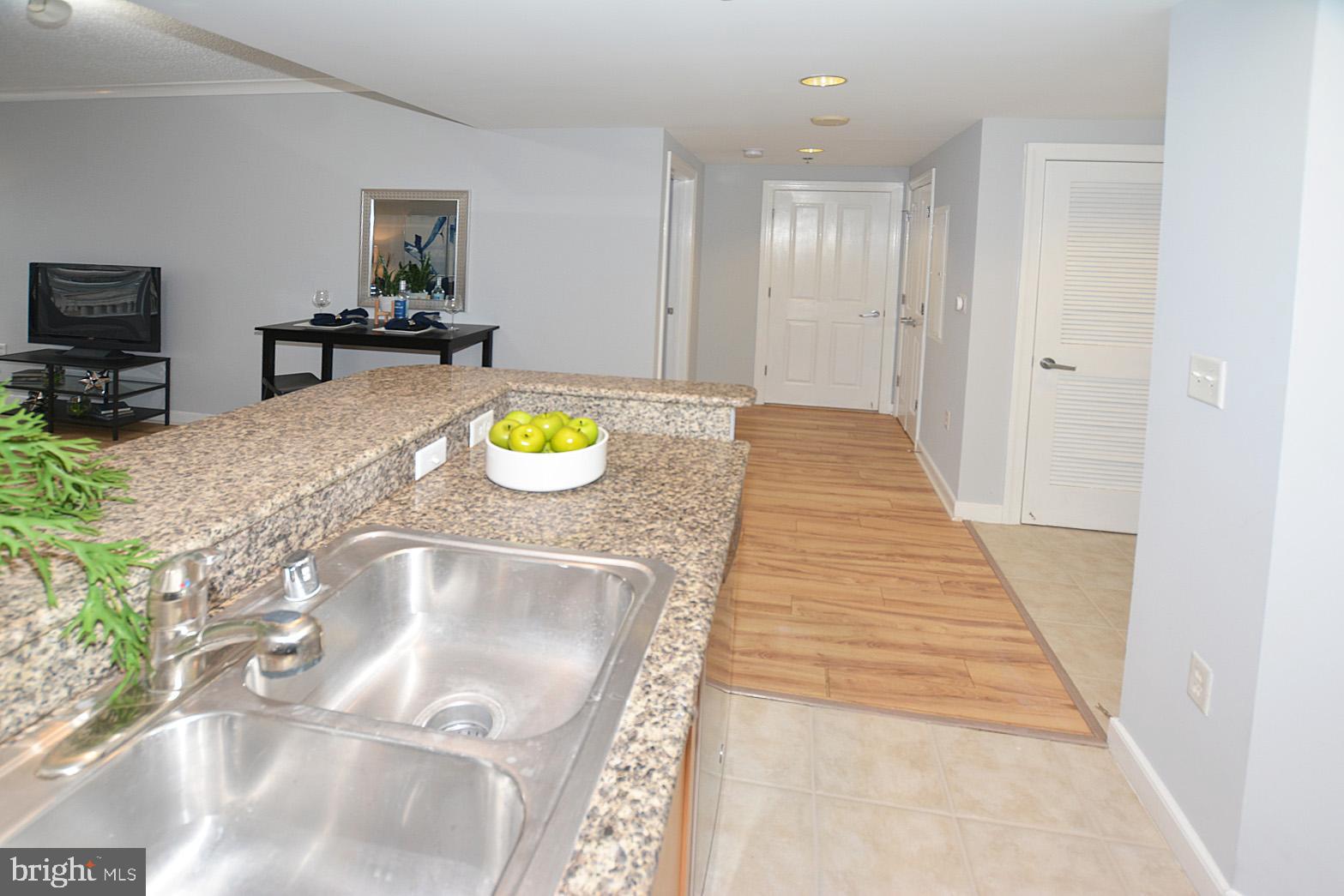 777 7th Street Northwest, Unit 1014 Washington, DC 20001 - Photo 22 of 43 a bathroom with a granite countertop sink a toilet and a mirror