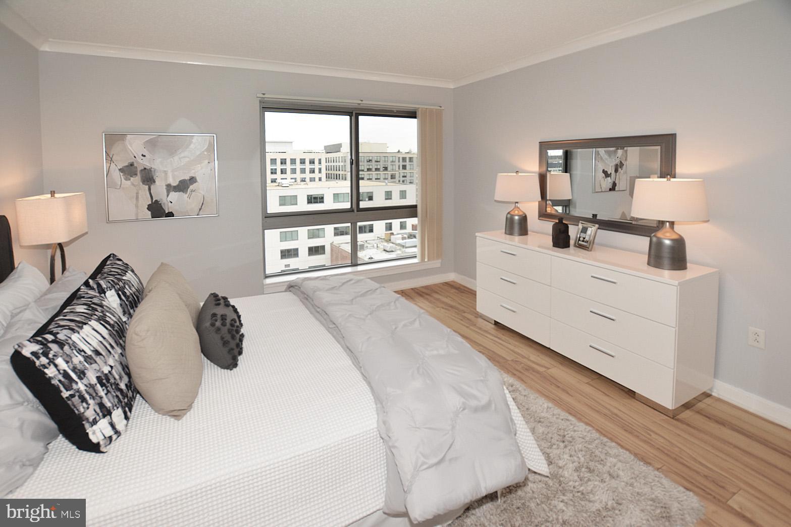 777 7th Street Northwest, Unit 1014 Washington, DC 20001 - Photo 24 of 43 a bedroom with a bed and a window