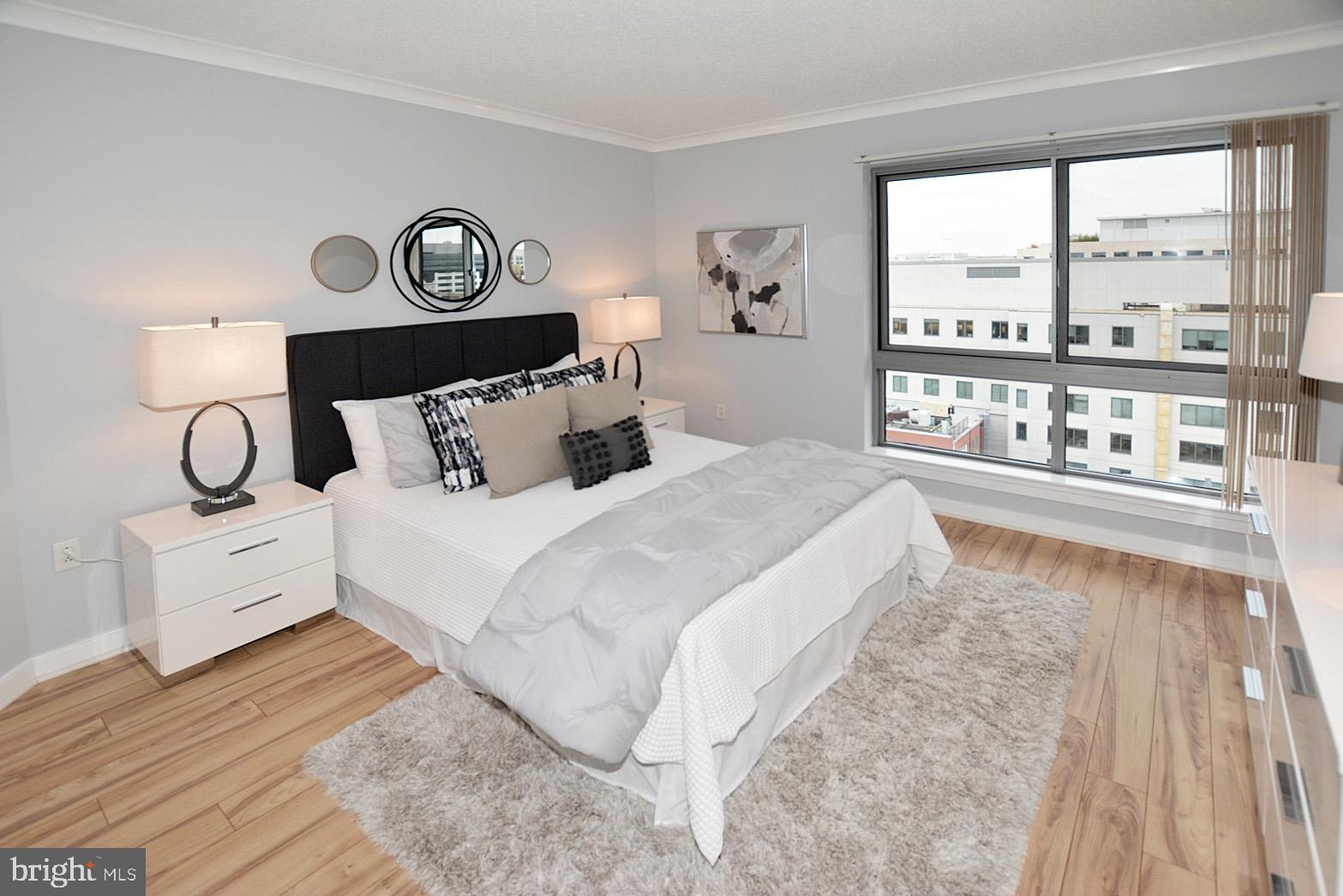 777 7th Street Northwest, Unit 1014 Washington, DC 20001 - Photo 25 of 43 a bedroom with a large bed and a window