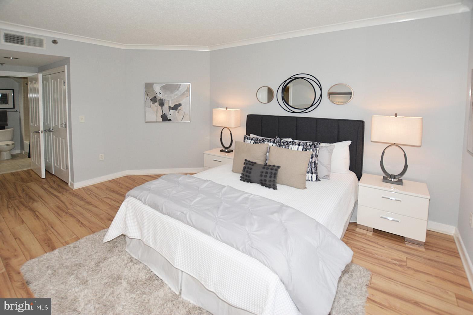 777 7th Street Northwest, Unit 1014 Washington, DC 20001 - Photo 26 of 43 a bedroom with a bed and painting on the wall