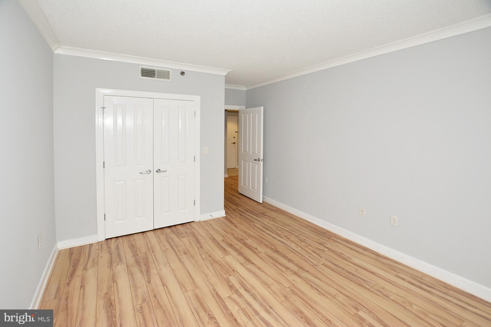 777 7th Street Northwest, Unit 1014 Washington, DC 20001 - Photo 29 of 43 a view of an empty room with wooden floor