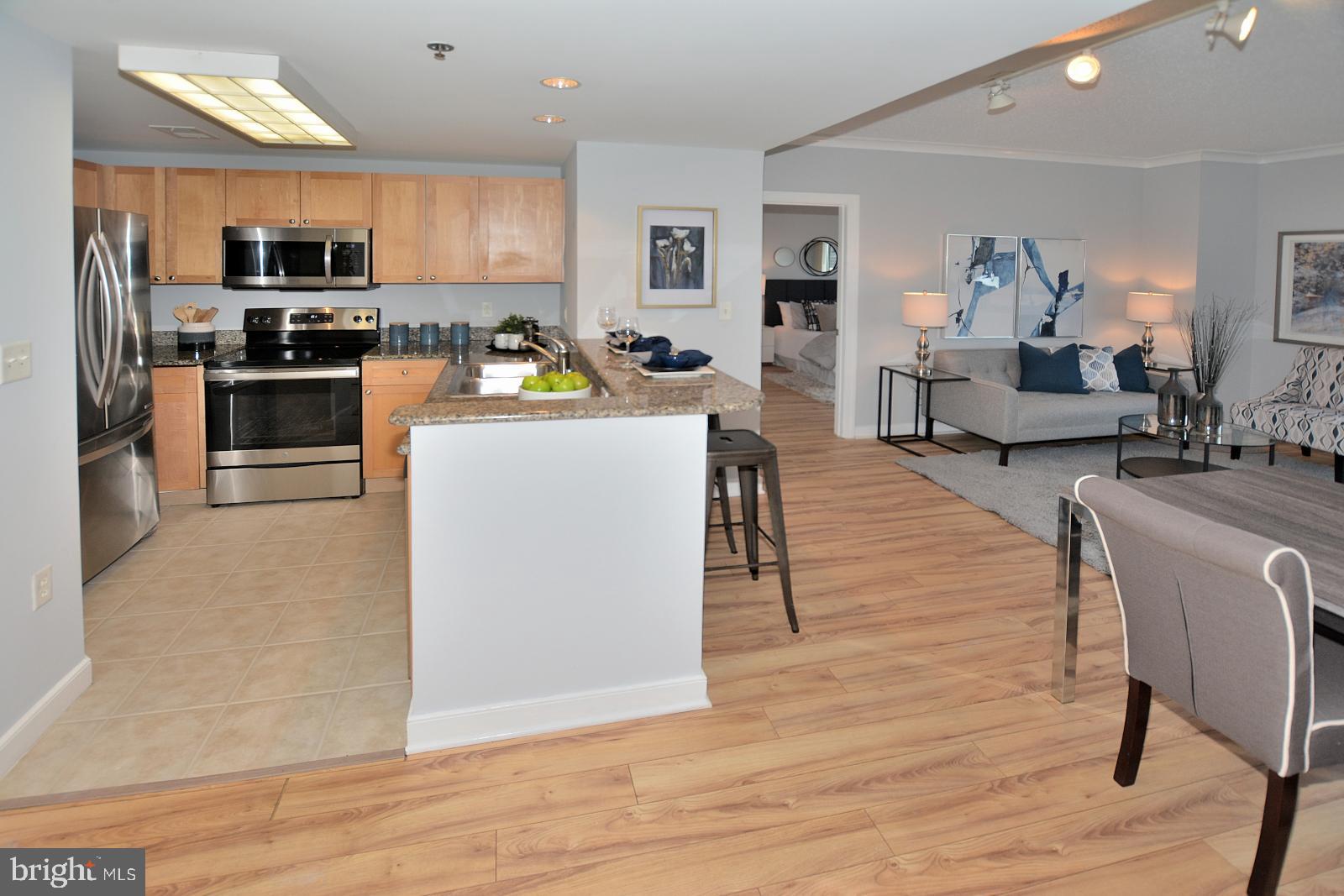 777 7th Street Northwest, Unit 1014 Washington, DC 20001 - Photo 32 of 43 a living room with stainless steel appliances furniture stove top oven and kitchen view