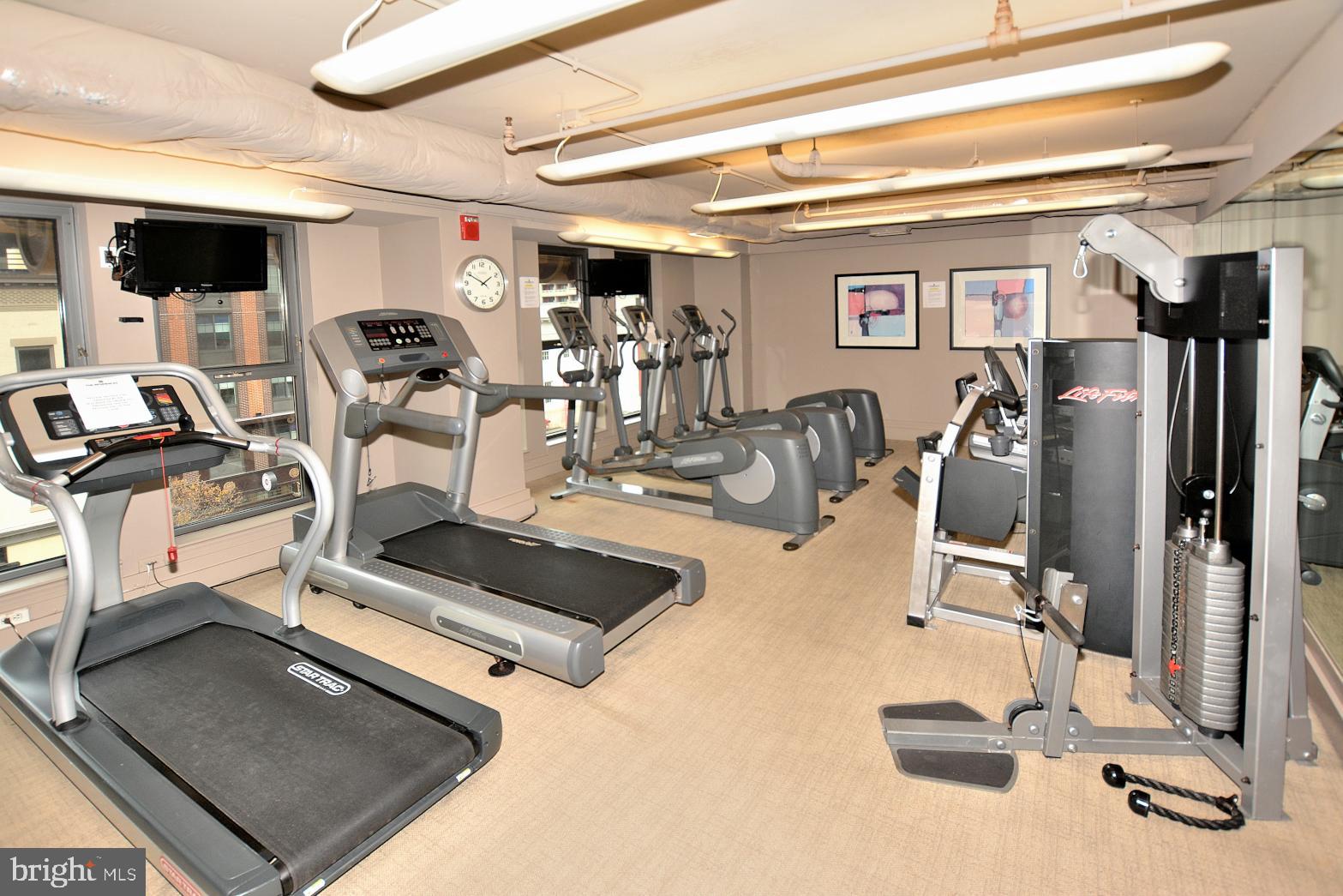 777 7th Street Northwest, Unit 1014 Washington, DC 20001 - Photo 39 of 43 a room with gym equipment and a large window