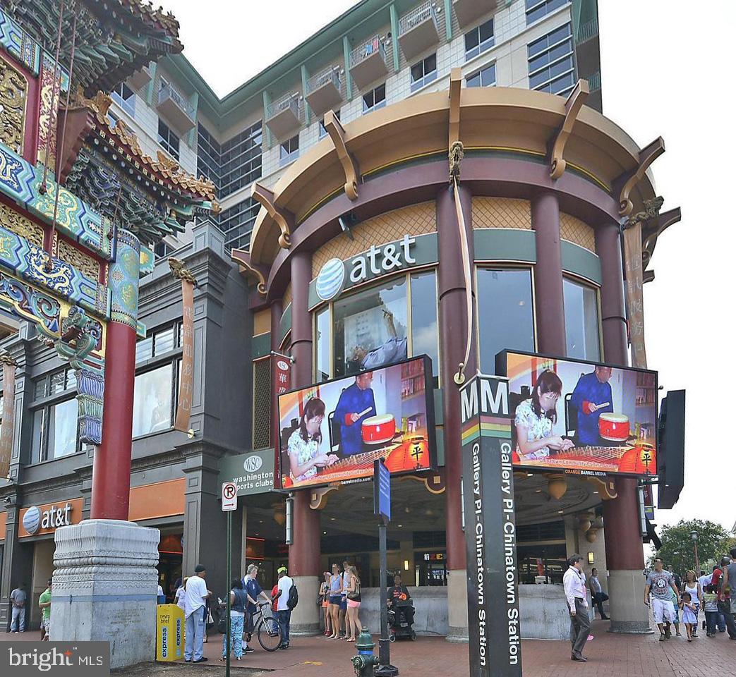 777 7th Street Northwest, Unit 1014 Washington, DC 20001 - Photo 42 of 43 a view of a building with retail shops and traffic signal