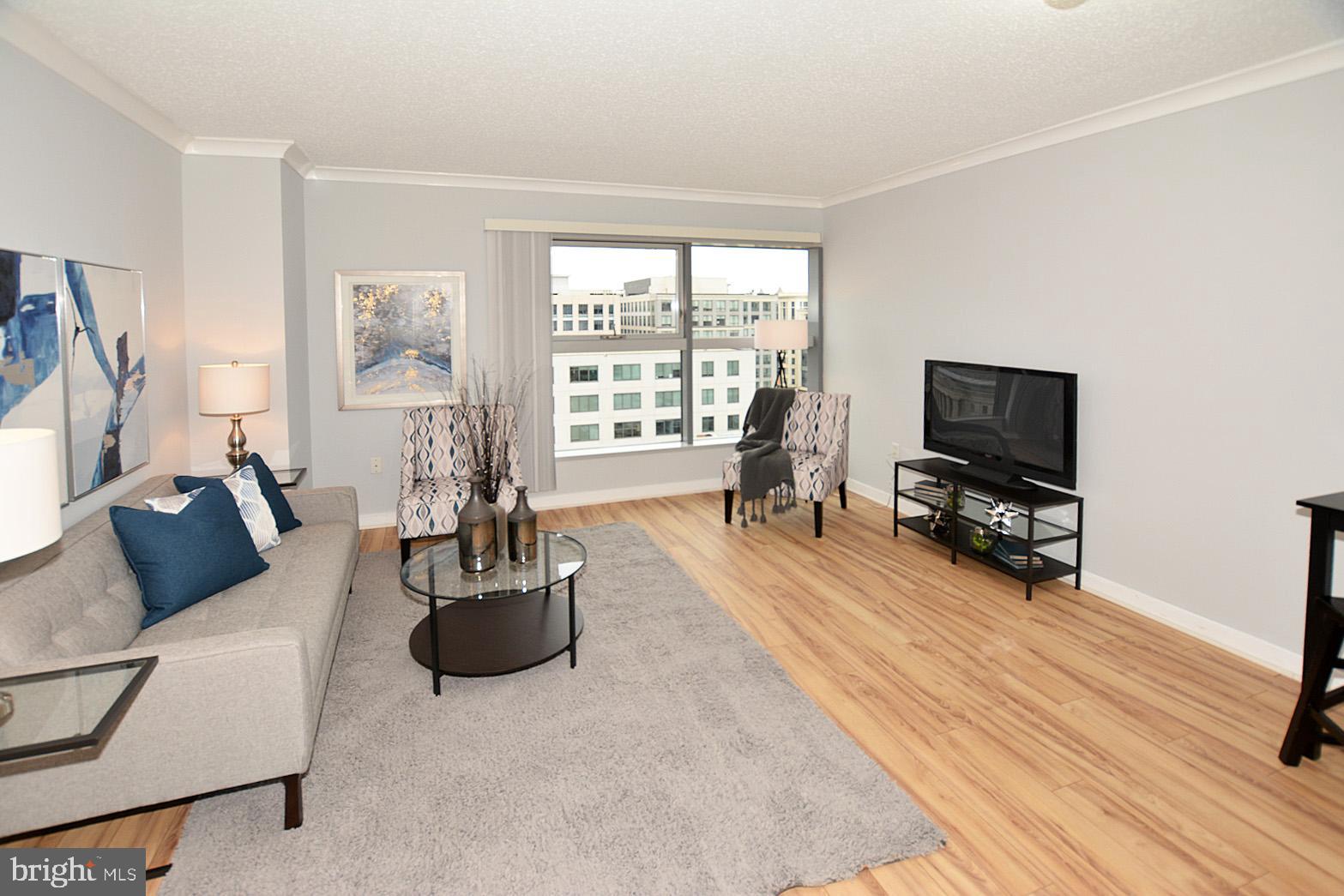 777 7th Street Northwest, Unit 1014 Washington, DC 20001 - Photo 7 of 43 a living room with furniture and a flat screen tv