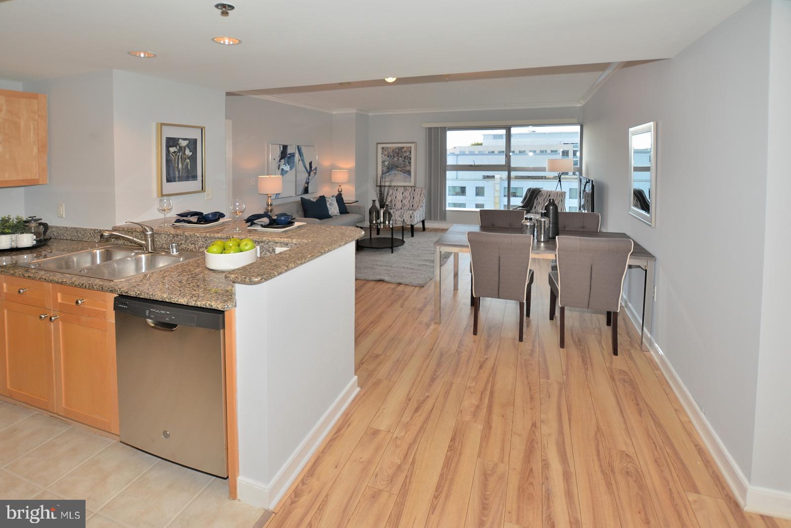 777 7th Street Northwest, Unit 1014 Washington, DC 20001 - Photo 9 of 43 a view of a kitchen with kitchen island wooden floors and center island