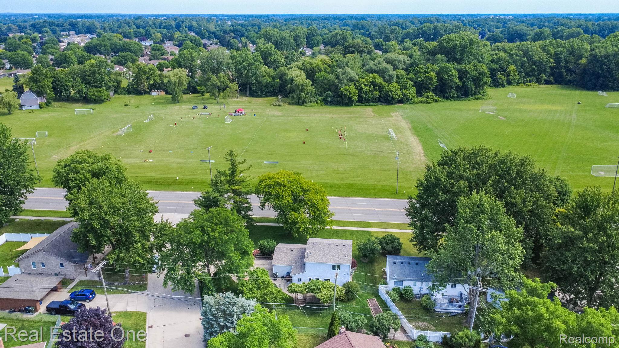 13912 Clinton River Road Sterling Heights, MI 48313 - Photo 40 of 43 Aerial perspective of a neighborhood setting with verdant trees and open green spaces