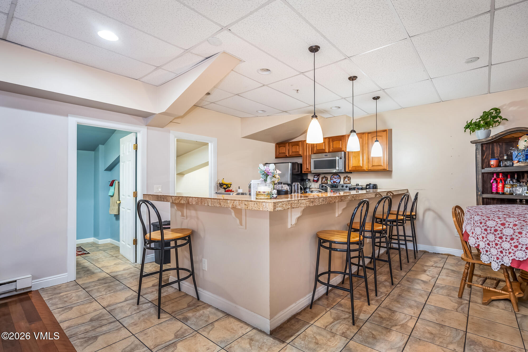 5 Murray Road, Unit B4 Edwards, CO 81632 - Photo 16 of 28 a kitchen with stainless steel appliances kitchen island granite countertop a table and chairs in it