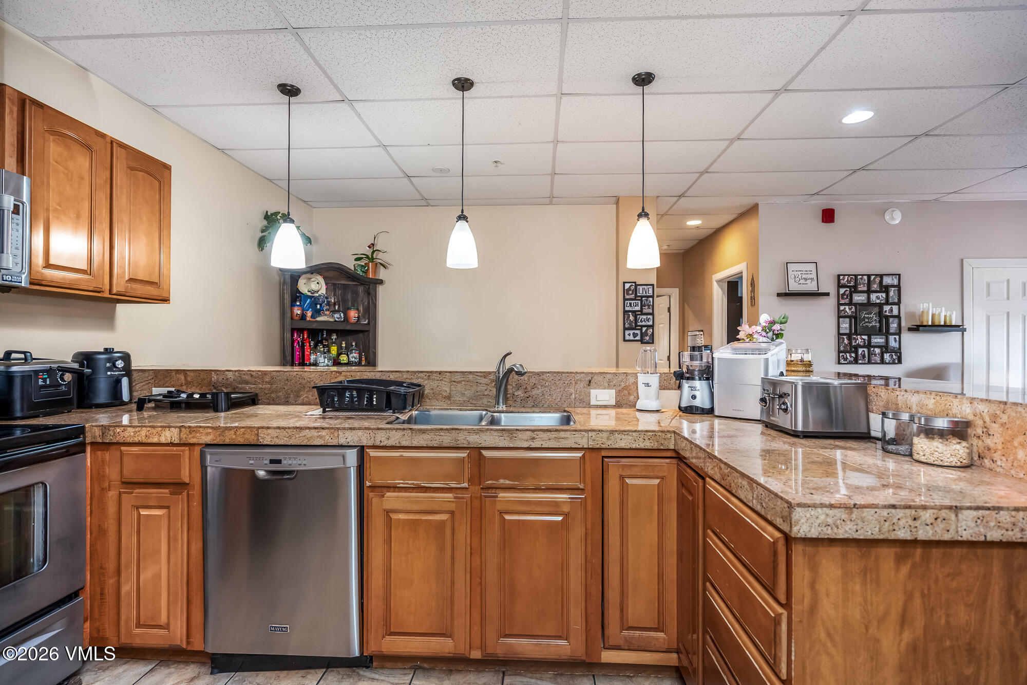 5 Murray Road, Unit B4 Edwards, CO 81632 - Photo 17 of 28 a kitchen with granite countertop a sink a counter space appliances and cabinets