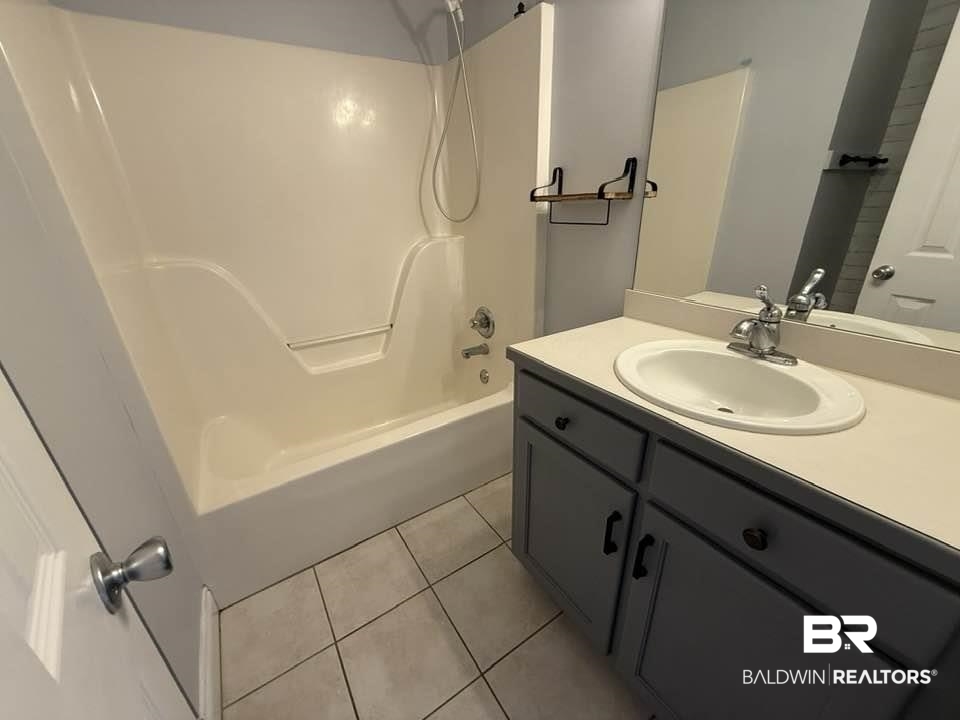 10428 South Side Loop Fairhope, AL 36532 - Photo 28 of 28 Full bath with shower combination, vanity, and tile patterned floors