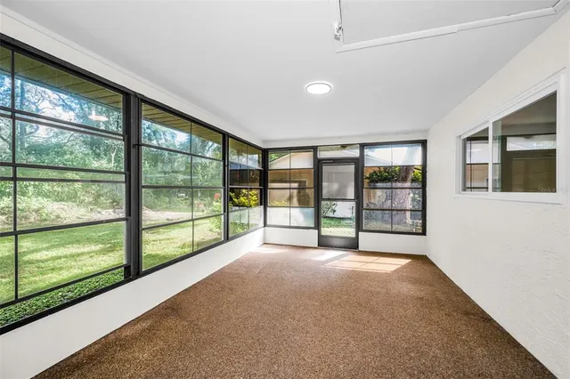 a view of an empty room with windows