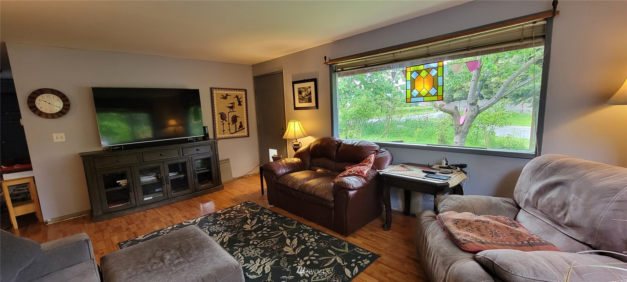 1224 Mission Road Everson, WA 98247 - Photo 4 of 30 a living room with furniture a flat screen tv and a floor to ceiling window
