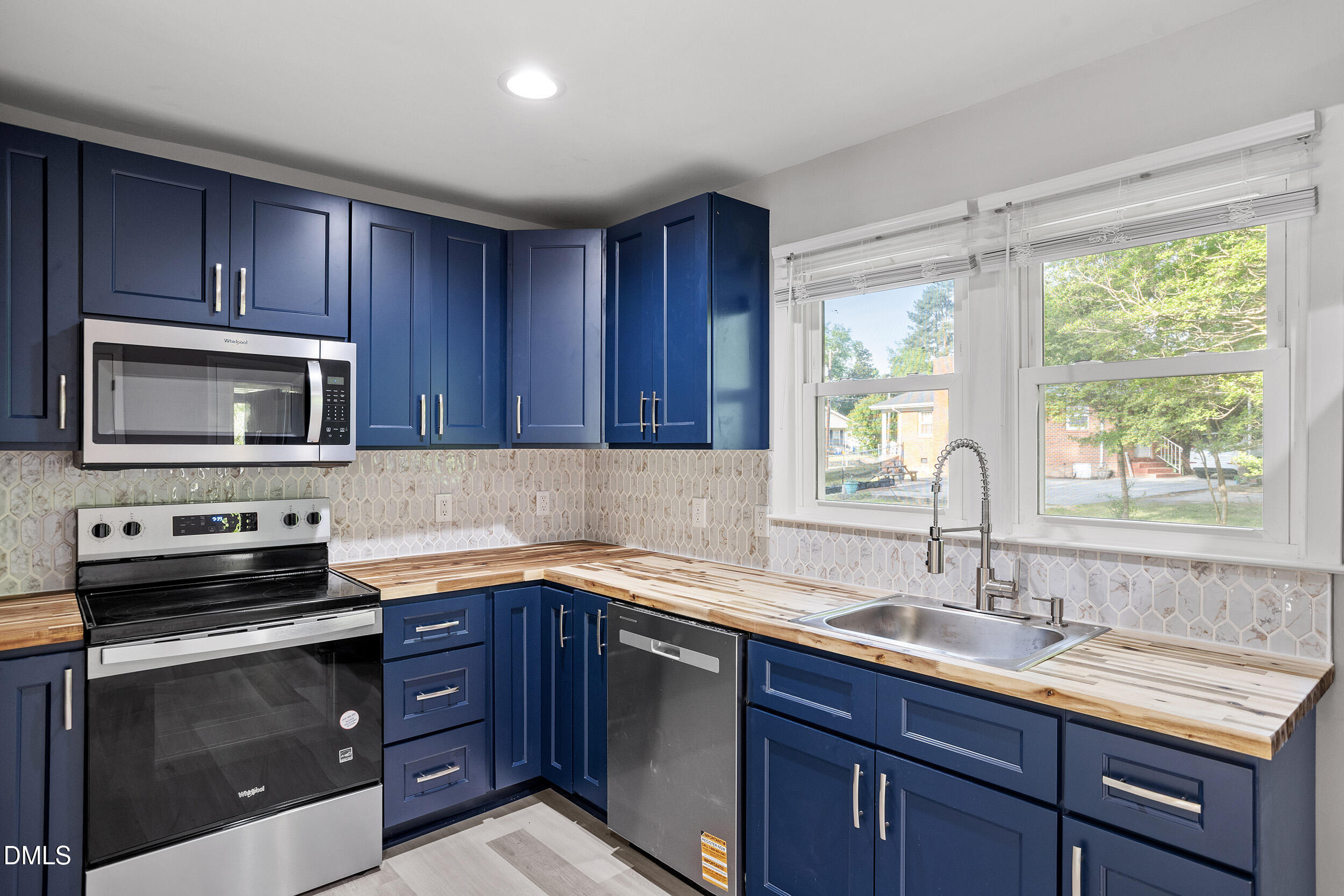 2414 Chapin Street Durham, NC 27707 - Photo 9 of 30 a kitchen with a sink stove top oven and cabinets