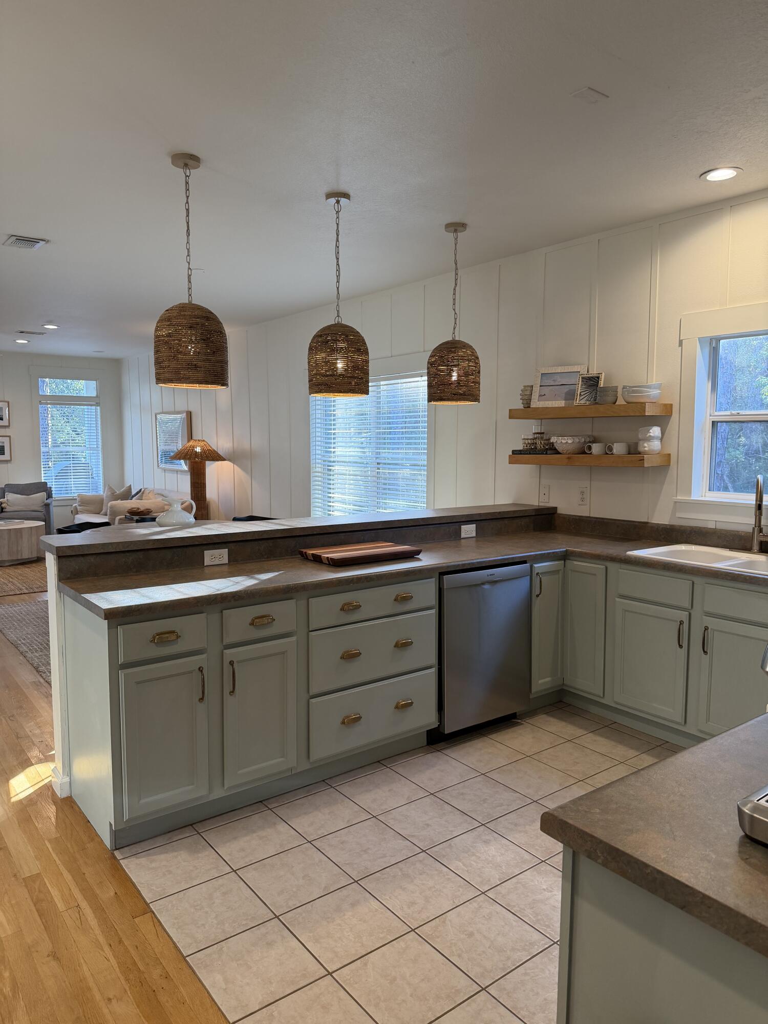 176 Georgie Street Santa Rosa Beach, FL 32459 - Photo 13 of 31 a kitchen with stainless steel appliances granite countertop a sink a stove and a wooden floors