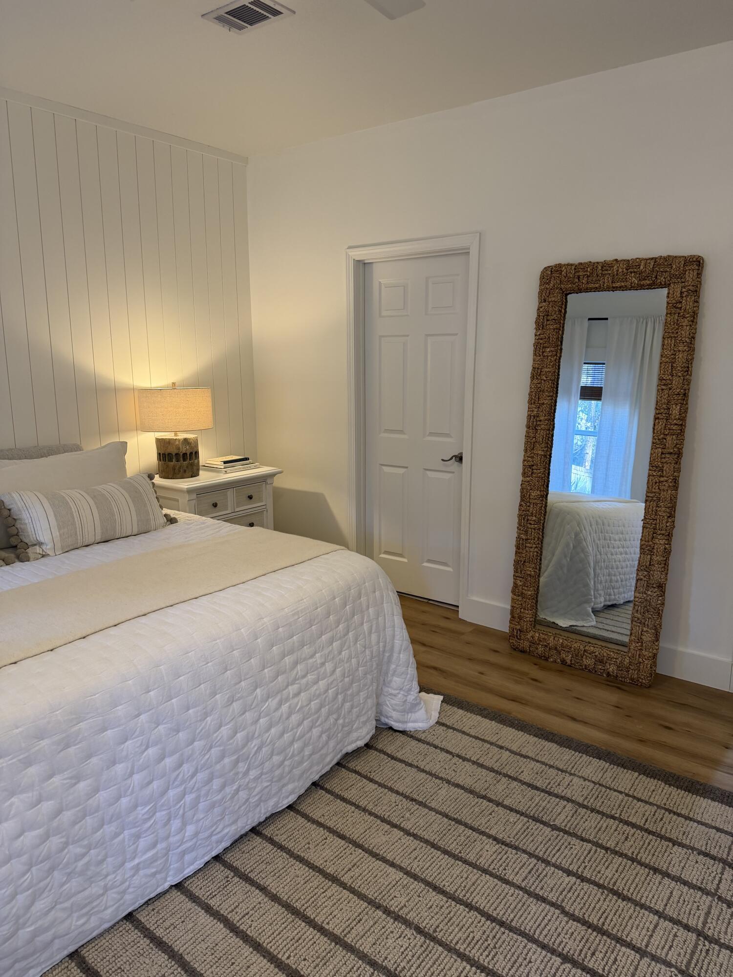 176 Georgie Street Santa Rosa Beach, FL 32459 - Photo 17 of 31 a bedroom with a bed and a mirror on dresser