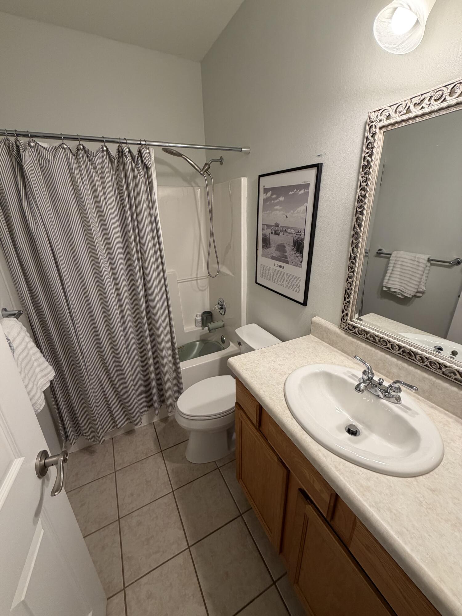 176 Georgie Street Santa Rosa Beach, FL 32459 - Photo 26 of 31 a bathroom with a sink a toilet and shower curtain