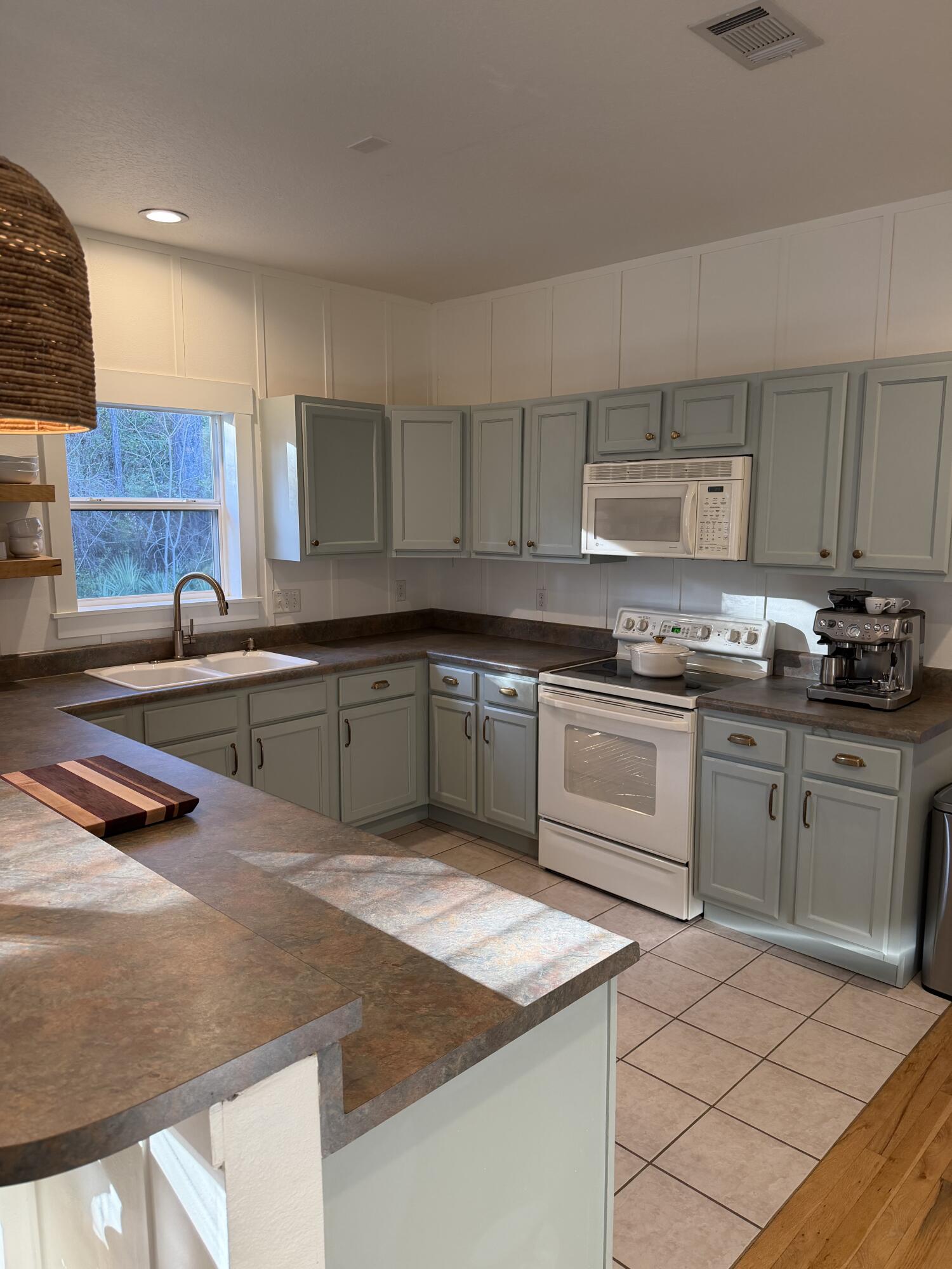 176 Georgie Street Santa Rosa Beach, FL 32459 - Photo 9 of 31 a kitchen with stainless steel appliances granite countertop a sink and cabinets