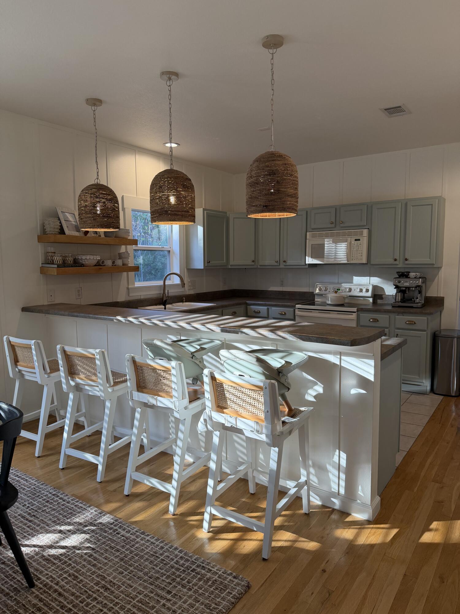 176 Georgie Street Santa Rosa Beach, FL 32459 - Photo 10 of 31 a kitchen with stainless steel appliances granite countertop a stove a sink and a wooden floors