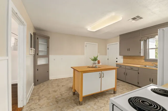 a kitchen with a sink and a stove top oven