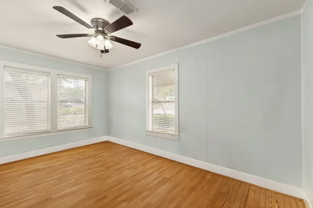 wooden floor in an empty room with a window