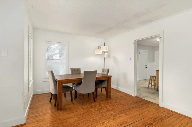 a view of a dining room with furniture and wooden floor