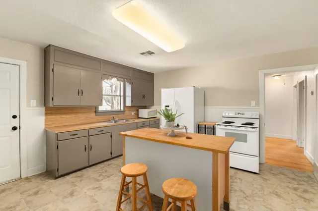 a kitchen with a sink appliances and cabinets