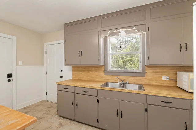 a kitchen with sink and window