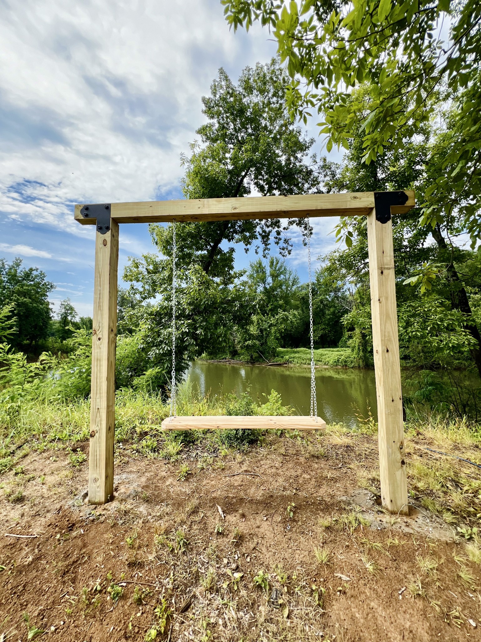 6725 Cravens Road Savannah, TN 38372 - Photo 1 of 11 a view of a small yard in front of a house with a large tree and plants