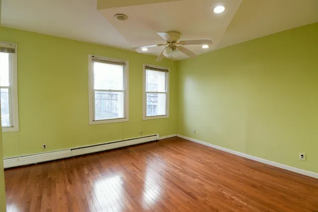 a view of room with window and wooden floor