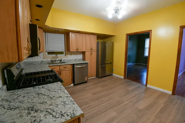 a kitchen with a stove and a refrigerator