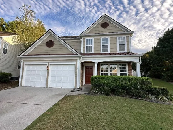 a front view of a house with a yard and garage