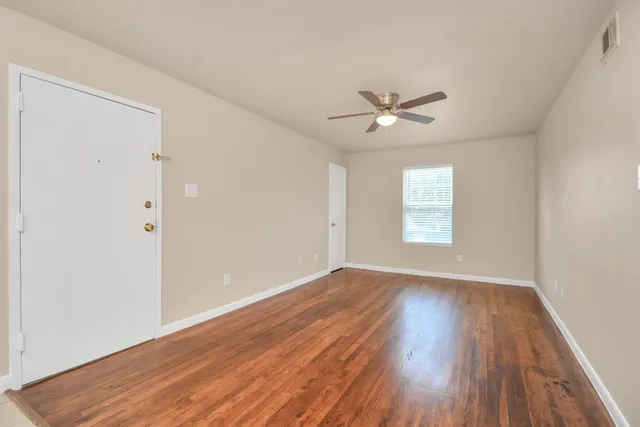 wooden floor in an empty room with a window
