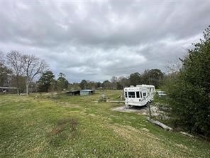111 County Road 1333 Liberty, TX 77575 - Photo 11 of 32 a view of a lake with house in the background