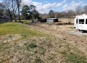 111 County Road 1333 Liberty, TX 77575 - Photo 14 of 32 a view of a yard with wooden fence