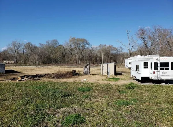 a view of yard with wooden fence