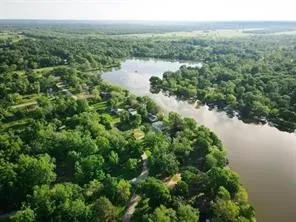 an aerial view of a golf course with a lake view