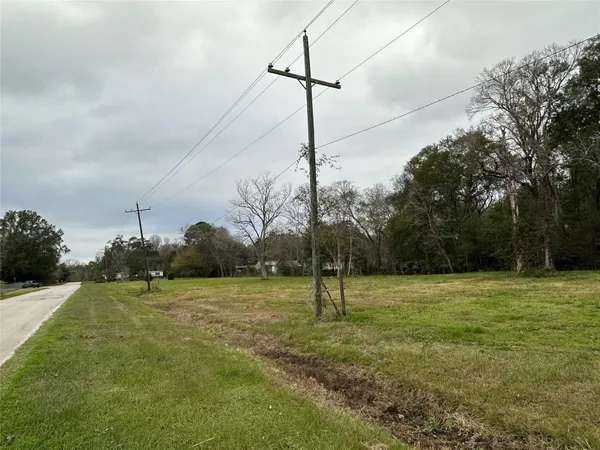 a view of a house with yard and sitting area