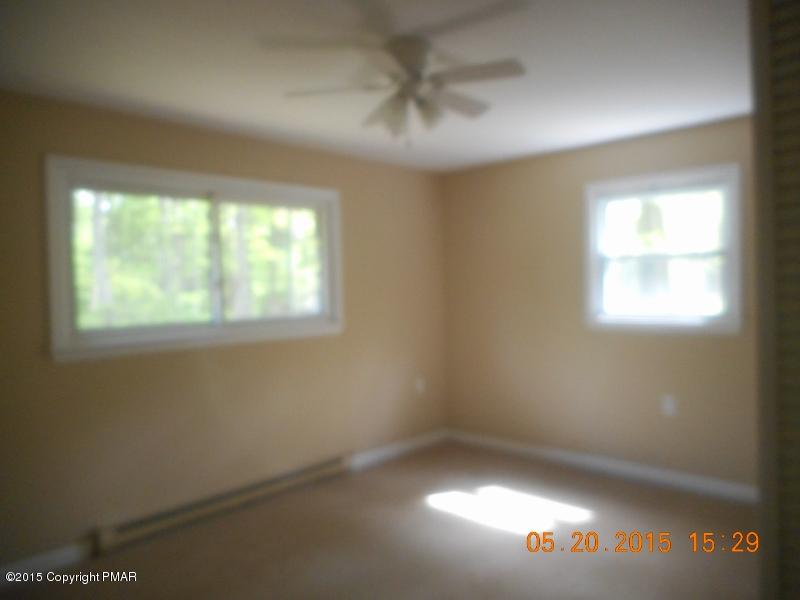 413 Devils Hole Road Cresco, PA 18326 - Photo 6 of 15 an empty room with a window and a ceiling fan