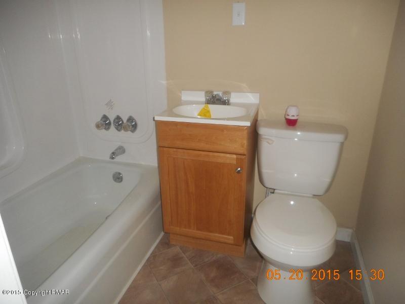 413 Devils Hole Road Cresco, PA 18326 - Photo 10 of 15 a bathroom with a toilet a sink and bathtub