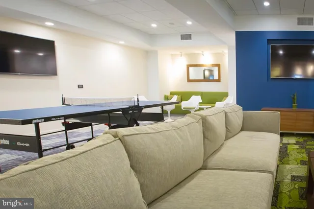 a view of a livingroom with furniture and a flat screen tv