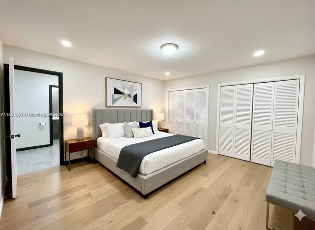 a spacious bedroom with a bed and a couch