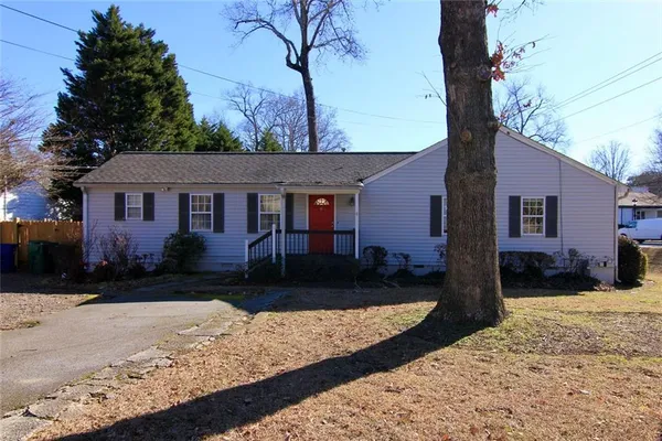 a front view of a house with a yard covered in snow