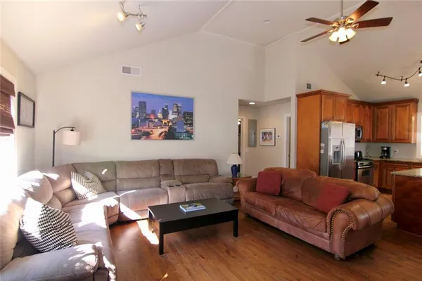 a living room with furniture and a chandelier